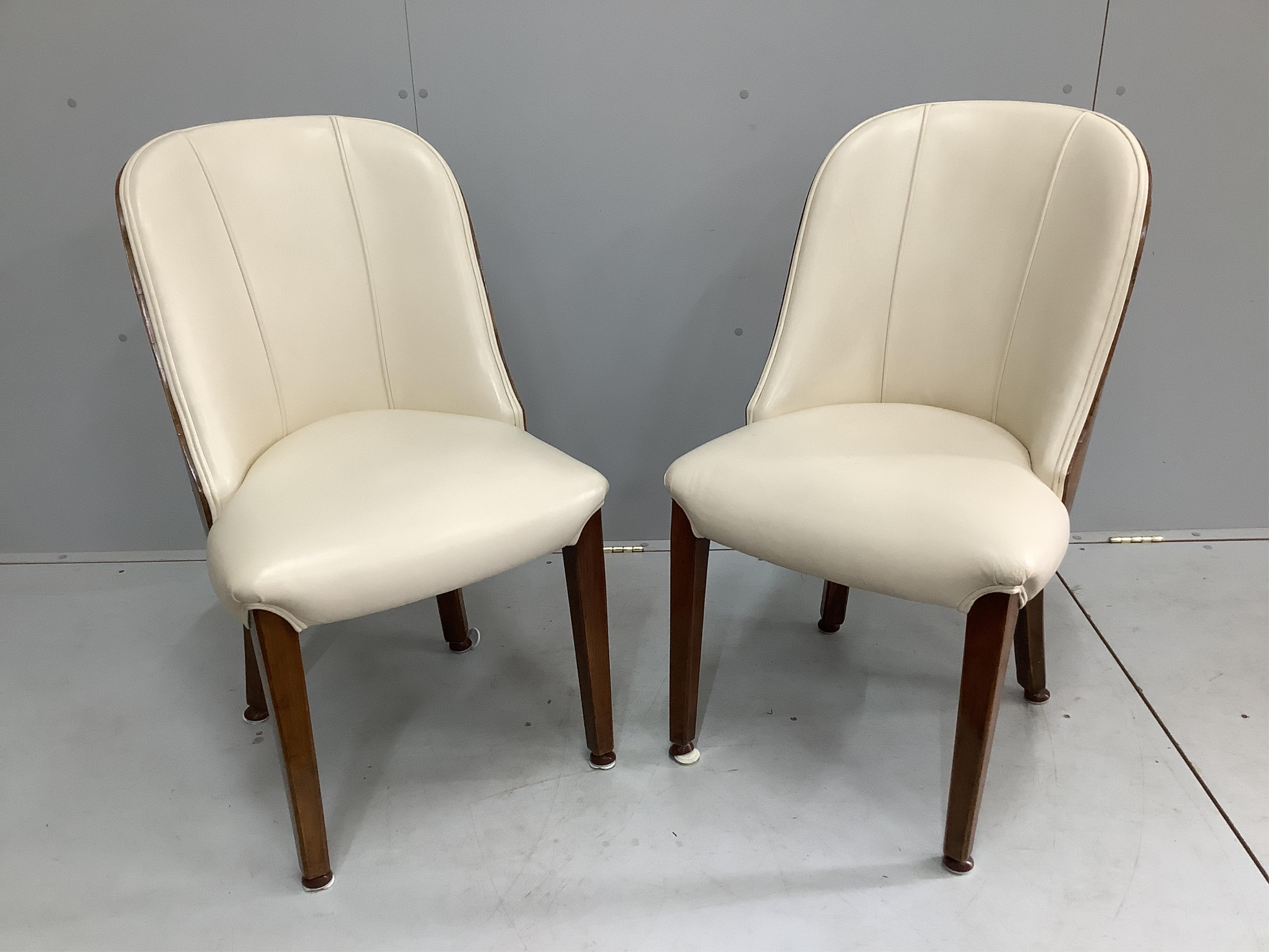 A pair of Art Deco burr walnut and ivory leather chairs